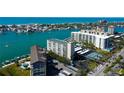 High rise condo building with community pool, tennis, and waterfront with bay and Gulf views at 660 Island Way # 202, Clearwater Beach, FL 33767