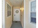 Charming entryway featuring a decorative wreath on the front door and natural lighting at 6907 Stonesthrow N Cir # 2102, St Petersburg, FL 33710