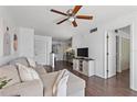 Cozy living room features hardwood floors, neutral decor, and an open layout at 6916 Stones Throw N Cir # 9110, St Petersburg, FL 33710