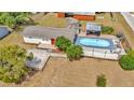 This aerial view showcases a home with a refreshing pool and a well-maintained outdoor space at 7421 Andre Dr, Zephyrhills, FL 33541