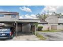 Charming townhome with covered parking, neutral paint, and landscaping on a partly cloudy day at 7912 Tangerine Dr, Temple Terrace, FL 33637