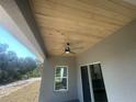 Covered patio featuring a wood ceiling with fan, offering a great outdoor living space at 8204 Chimney Rock Dr, Webster, FL 33597
