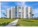 Beautiful condo building with a manicured lawn and landscaping, offering a serene residential setting at 851 Bayway Blvd # 904, Clearwater Beach, FL 33767