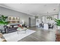 Bright and airy living room featuring hardwood floors and neutral decor at 9108 Woodbay Dr, Tampa, FL 33626