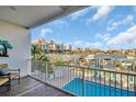 Balcony view with a waterfront pool and nearby boat docks overlooking the city skyline at 130 Brightwater Dr # 5, Clearwater Beach, FL 33767