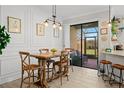Cozy dining area with rustic table, adjacent to screened patio access, and kitchen view at 30045 Southwell Ln, Wesley Chapel, FL 33543