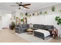 Comfortable living room featuring a large sectional sofa and stylish decor at 30045 Southwell Ln, Wesley Chapel, FL 33543