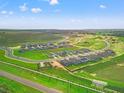 An aerial view shows newly constructed homes in a neighborhood with green spaces and a blue sky at 31660 Malbec Dr, Brooksville, FL 34602