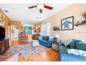 Open-concept living space with hardwood floors and views into the eat in kitchen at 31836 Stillmeadow Dr, Wesley Chapel, FL 33543