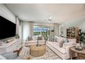 Spacious living room with comfortable seating and an open view to the screened outdoor pool at 3915 Farm Garden Ct, Lakewood Ranch, FL 34211