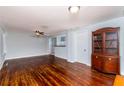 Open living room with hardwood floors, fan, and view into kitchen area at 4162 3Rd N Ave, St Petersburg, FL 33713