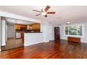Living room featuring hardwood floors, kitchen view, and natural light from window at 4162 3Rd N Ave, St Petersburg, FL 33713