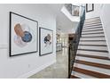 Elegant staircase with wrought iron railing, complemented by modern artwork at 4907 Bayshore Blvd # 115, Tampa, FL 33611