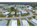 An aerial view of a single-story home in a well-manicured community with mature trees at 4920 Blanco Dr, Zephyrhills, FL 33541