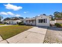 Street view of a one-story home with a driveway and bright exterior paint at 6337 S Lansdale Cir, Tampa, FL 33616