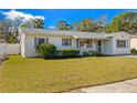 Charming one-story home featuring well-maintained landscaping, lush green grass, and bright exterior paint at 6337 S Lansdale Cir, Tampa, FL 33616