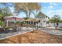 Spacious backyard with stone patio, outdoor seating, dining area, and cozy lounge space at 6835 S Shamrock St, Tampa, FL 33616