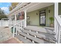 Inviting front porch with decorative columns and classic front door at 6835 S Shamrock St, Tampa, FL 33616