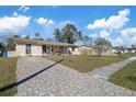 This is a single story home with a brick driveway and sidewalk located in a suburban neighborhood at 8343 Galewood Cir, Tampa, FL 33615