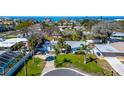 Charming single-story home with lush landscaping and well-manicured lawn near the water at 920 Spruce Dr, Belleair Beach, FL 33786