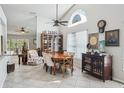 Inviting dining room with high ceilings, a decorative window, a wooden table with seating for six, and stylish décor at 12030 Steppingstone Blvd, Tampa, FL 33635