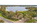 Aerial view of the property showcasing its location near a serene lake and lush greenery at 14333 Lake Magdalene Blvd, Tampa, FL 33618