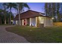 Beautiful home with manicured lawn and landscape lighting enhancing the exterior at 14333 Lake Magdalene Blvd, Tampa, FL 33618