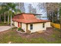 Well-maintained home featuring a unique roof, stone accents, and a spacious backyard at 14333 Lake Magdalene Blvd, Tampa, FL 33618