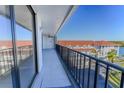 Enjoy outdoor living on this large balcony with black railings and views of the waterfront and complex at 19111 Vista Bay Dr # 401, Indian Shores, FL 33785