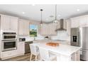 Modern kitchen boasts stainless steel appliances, a spacious island with seating, and ample counter space at 36812 Rio Grande Dr, Zephyrhills, FL 33540