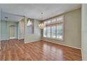 Spacious living room with hardwood floors, large windows, and a chandelier at 3904 Executive Cir, Plant City, FL 33566