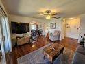 A bright living room with hardwood floors and an open floor plan to the dining area at 3934 37Th S St # 36, St Petersburg, FL 33711