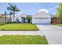 Inviting single-story home showcasing a spacious two-car garage and neatly maintained lawn at 4313 Brooke Dr, Valrico, FL 33594