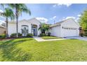 Well-maintained single-story home featuring lush green lawn, tropical landscaping, and a two-car garage at 4313 Brooke Dr, Valrico, FL 33594