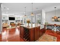 Open-concept kitchen with a large island, wine rack, farmhouse sink, and modern appliances at 4603 S Bartlett St, Tampa, FL 33611