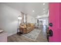 Open-concept living room featuring wood floors and seamless flow into the kitchen and dining area at 6907 N 12Th St, Tampa, FL 33604