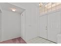 Bright entryway with tile floors, leading into the home at 726 Hidden Lake Dr, Tarpon Springs, FL 34689