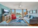 Well lit living room featuring a great view, stylish furniture, and hardwood floors at 7400 Sun Island Drive S # 712, South Pasadena, FL 33707