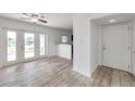 A bright living room with new flooring, and a view of the lake through the double doors at 108 Pompano Se Dr # A, St Petersburg, FL 33705