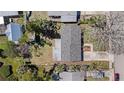 Aerial view of the home showing the roof, surrounding yard and nearby neighborhood streets at 202 Dunkirk Rd, Oldsmar, FL 34677