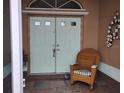 Charming front porch with double doors and comfortable wicker rocking chair at 28 Sportsman Pl, Rotonda West, FL 33947
