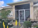 Inviting screened entrance with decorative front door and lush landscaping at 28 Sportsman Pl, Rotonda West, FL 33947