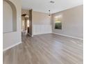 Open-concept living room featuring modern flooring, neutral paint, and decorative wall trim at 3031 Downan Point Dr, Land O Lakes, FL 34638