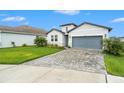 Beautiful single-Gathering home featuring a manicured lawn and a stylish two-car garage at 34303 Radley Way, Wesley Chapel, FL 33545