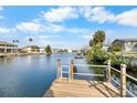 Scenic view from a private wooden dock extending into the serene waterway, perfect for boating and relaxation at 3515 Centavo Ct, Hernando Beach, FL 34607