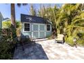 Cozy backyard featuring a storage shed with a seating area at 410 Georgia Ave, Crystal Beach, FL 34681
