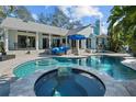 Stunning pool and spa with a spacious patio, perfect for outdoor relaxation and entertaining at 436 3Rd N Ave, Tierra Verde, FL 33715