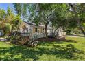 Well-maintained home with shutters, front porch, and landscaped yard with mature trees at 4944 28Th S Ave, Gulfport, FL 33707