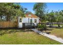 Charming one-story home with a manicured lawn, light blue door, and inviting front porch at 4944 28Th S Ave, Gulfport, FL 33707