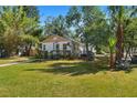 Charming one-story home with a manicured lawn, light blue door, and inviting front porch at 4944 28Th S Ave, Gulfport, FL 33707